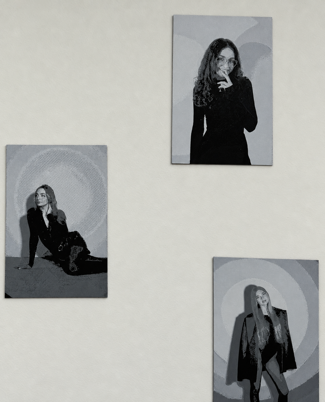 Three monochrome 3D-printed portrait canvases installed on a wall