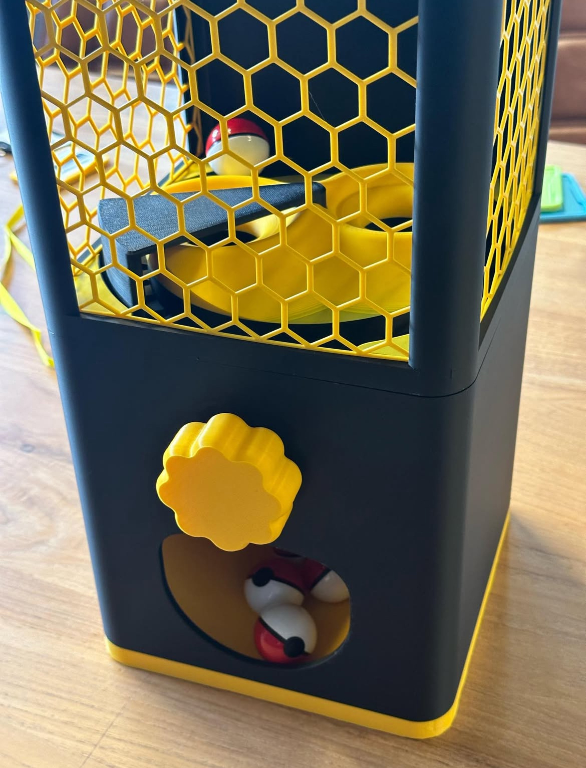Close-up of the control and capsule opening on the gacha machine