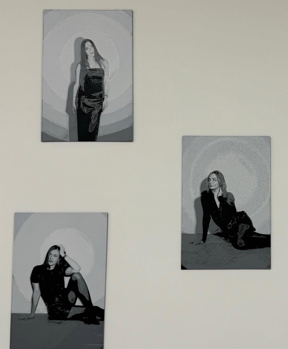 Three additional 3D-printed portrait canvases displayed on a wall